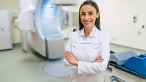 GTN medical technology field services technician in front of equipment
