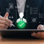 Digital recruitment process with HR manager selecting candidate using tablet in office environment, representing human resource technology and technical team augmentation provider in modern business workflow.