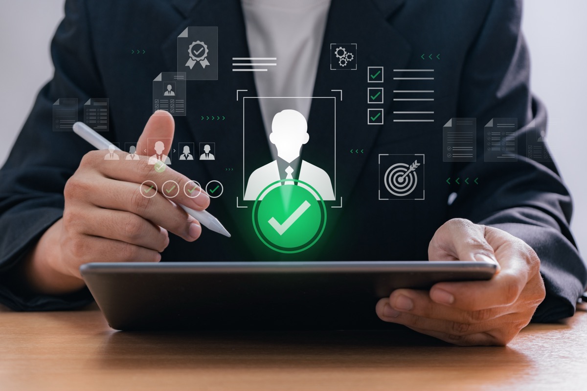 Digital recruitment process with HR manager selecting candidate using tablet in office environment, representing human resource technology and online hiring system in modern business workflow Digital recruitment process with HR manager selecting candidate using tablet in office environment, representing human resource technology and technical team augmentation provider in modern business workflow.