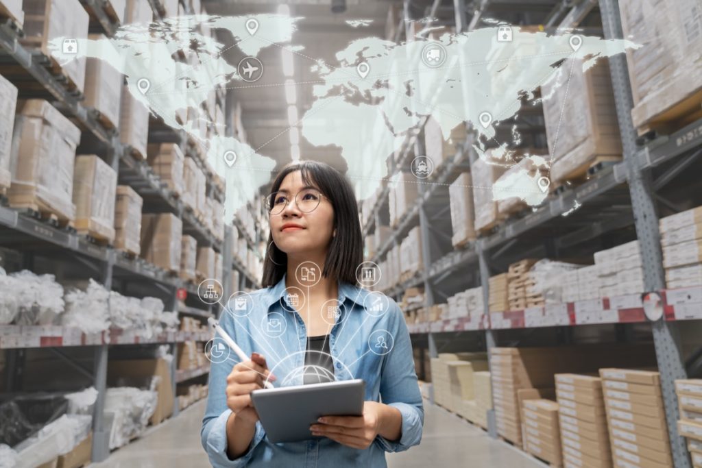 Portrait of procurement specialist looking at inventory in warehouse using smart tablet in management technology, interconnected industry, and enterprise business concept.